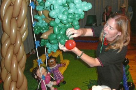 Janice Spagnola adding an apple to a balloon tree during a live balloon installation for the Niagara County Fair