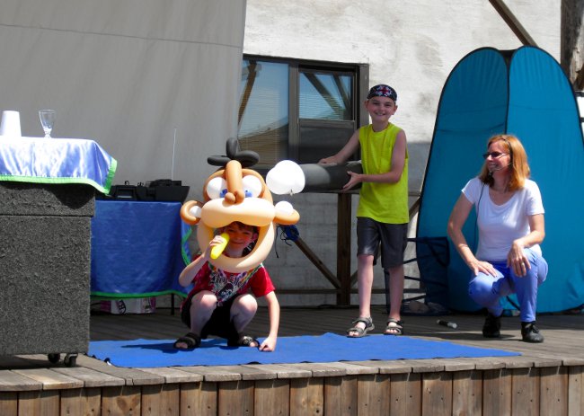 Two kids on stage with Janice during a Balloon Show