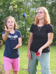 Janice teaching a student to juggle