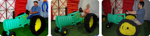 Different people getting their photo taken on the balloon tractor