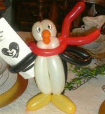 Balloon Penguin Table Topper holding a menu
